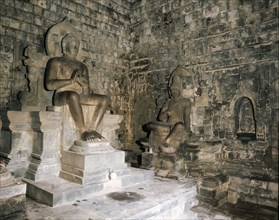 Statues of Buddha and a Bodhisattva in Chandi Mendut, one of the several temples associated with Borobudur