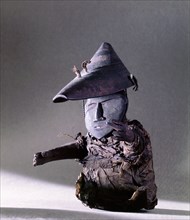 A small figure of a man wearing a wooden hunting hat