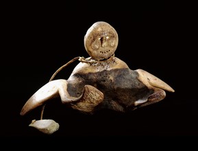 A figurine depicting a shaman in the midst of leaving his body in spirit form to fly to other parts of the world
