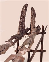 Phallic figures surmounting Asmat pole sculptures known as bis poles