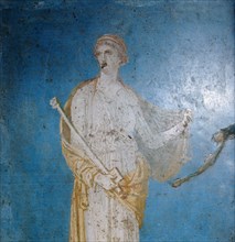 Fresco of a woman standing against a blue background