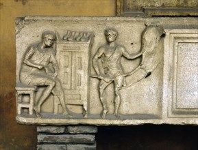 Part of a sarcophagus with a relief showing a shoemaker at work