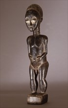 Baule figure sculpture represents either nature spirits of a spirit wife or husband