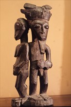 Baule figure sculpture carved for a spirit trance diviner as a focus for sacrifice, It may represent the female diviner protected by the bush spirit that possesses her