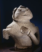 Dogu figure in the form of a human torso with the left arm across the breast