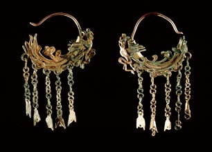 A pair of silver earrings, encrusted in parts with malachite and shaped in the form of dragon like creatures