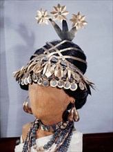 Mounted on a model are hair ornaments, earrings and necklaces