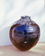 A Sung dynasty black ware vase, the Chinese inscription indicating the type of tea it contained