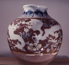 A pot with an underglaze painting of Taoist symbols, the dragon and the peony