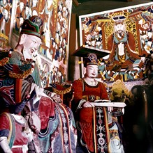 Thankas and statues of Taoist sages or monks inside the temple on Diamond Mountain