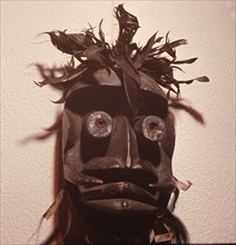 A mask of the kagle type, depicting a chimpanzee, used in performances that provoke the audience with wild dancing and outrageous behaviour