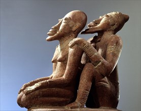 Terracotta figures of a man seated behind a woman