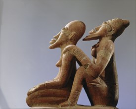 Terracotta figures of a man seated behind a woman