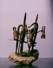 A sculpture from an ancestral shrine incorporating representations of spears and bells