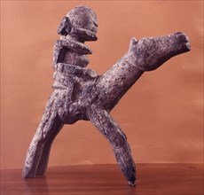 A root carving representing a horse and rider