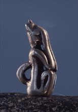An amulet in the form of a nommo figure in the shame position