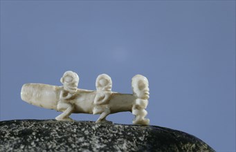 Ivory ear bolt decorated with three small tiki figures