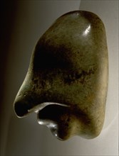 Miniature jadeite head in the form of a person wearing a half mask of a bird or serpent