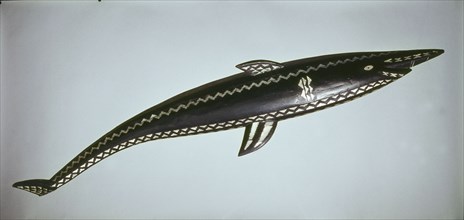 Large inlaid carving which represents a shark, or when inverted, a bonito fish