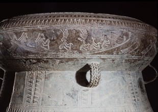 Detail of decoration on a Dong Son drum, depicting figures with feathered headdresses in a boat
