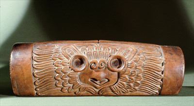 A teponaztli or two toned drum with a horned owl carved on the side