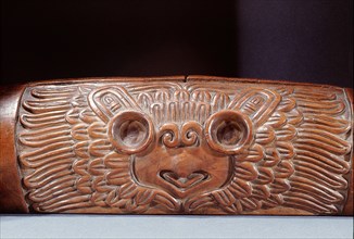 A teponaztli or two toned drum with a horned owl carved on the side