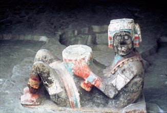 Close up of polychrome Chac Mool figure (reclining human figure with a sacrificial tray on his lap)