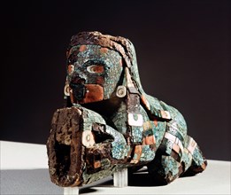 The handle of a sacrificial knife in the form of a kneeling deity