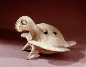 Ceramic flute of the kind known as ocarina in the shape of a macaw or parrot