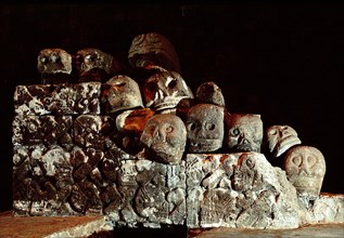Collapsed carving of a Tzompantli, or skull rack