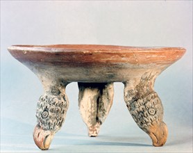 Painted bowl standing on feet in the form of eagles heads which may indicate that the bowl was part of a warriors household