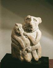 Seated erotic figures of a man and an animal headed figure
