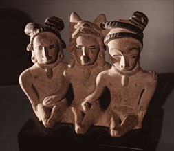 Three seated figures, a man flanked by two women