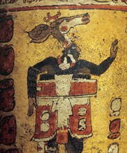 Cylindrical vessel decorated with date glyphs and a Mayan ball player wearing black body paint and heavy padding for the competition