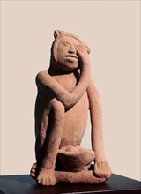 Figurine of a woman crying