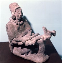 Figurine of a woman weaving