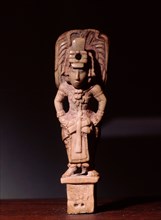 Bone carving of a Mayan dignitary wearing rich garments