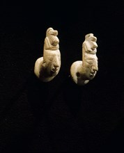 Stone ear plugs in the form of human heads