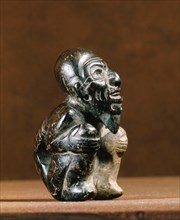 Olmec figure of a crouching man