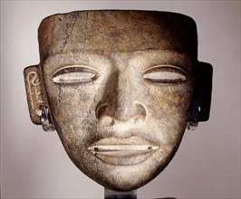 Stone funerary mask, placed on the face of an important corpse as part of the burial attire