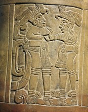 Detail of a pottery vessel depicting two warriors wearing bird headdresses, showing them to be nobles of very high rank
