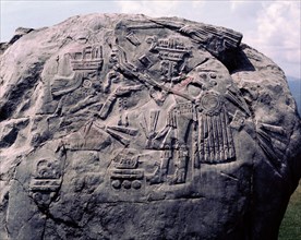 Colossal monolith with bas relief of a warrior and a woman