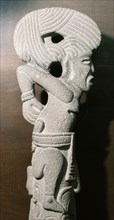 Stone carving (palmate) representing a prisoner with hands bound, possibly the victim of future sacrifice