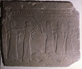 Elamite kings forced to act as servants at Ashurbanipals court