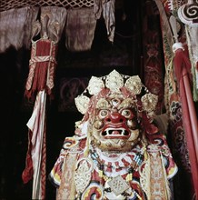 Mask in storage for the sacred Cham dance, representing the Spirit of Barren Mountain