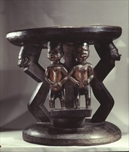 Stool supported by human figures, probably carved for an important elder or chief