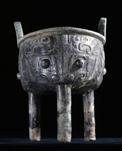 Archaic ding vessel decorated with large taotie masks