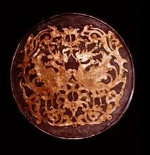The reverse of a mirror decorated in relief with a pair of phoenixes and yin yang symbols