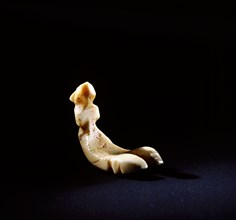 Small flat bottomed ivory carving of a sea bird, probably a gaming piece
