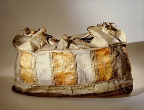 Storage bag made from pieces of bleached, dyed and untreated sealskin sewn together with overlapping seams to make it waterproof for boat travel